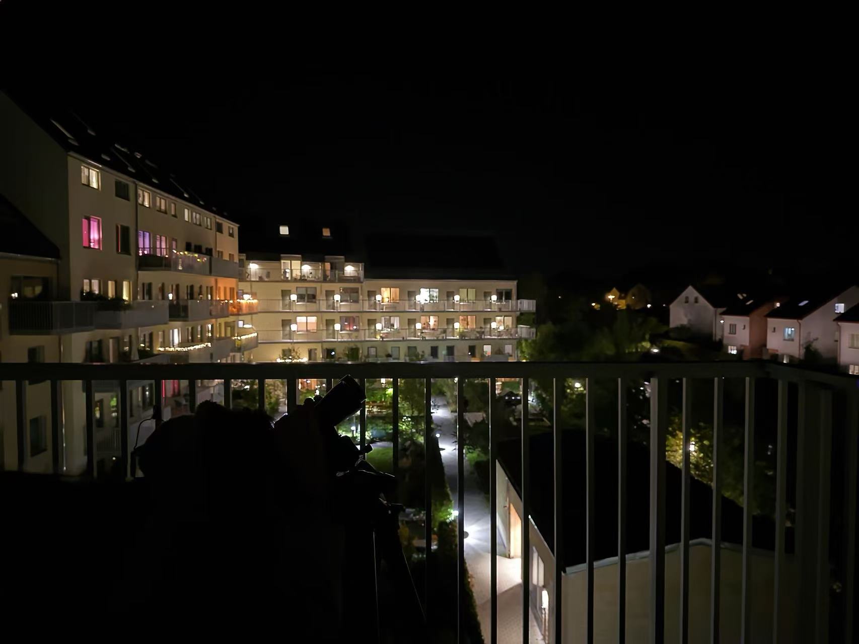 Binocular and tripod setup on balcony